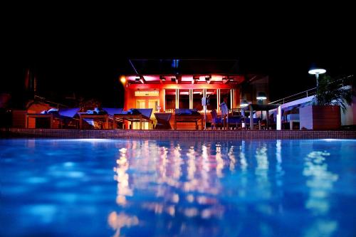 a swimming pool in front of a building at night at GHL Arsenal Hotel in Cartagena de Indias