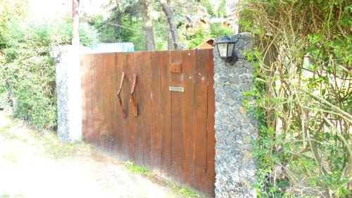 a wooden fence with a light on top of it at Cabañas Manamar in Villa Gesell