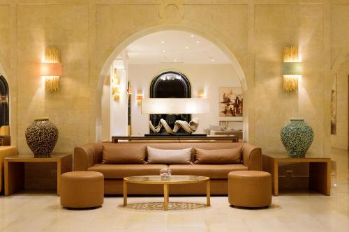 a living room with a couch and a table at Occidental Sousse Marhaba in Sousse
