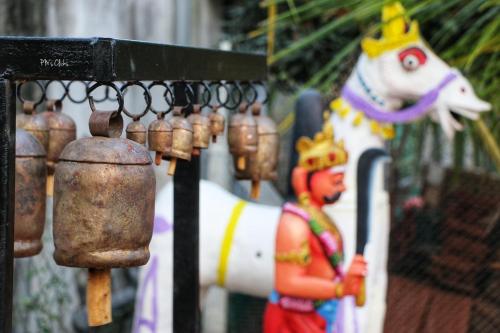a statue of a horse with a crown on its head at Marutham Village Resort in Mahabalipuram