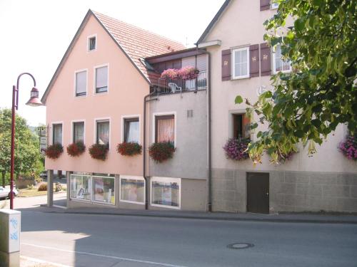 a building with flower boxes on the side of it at Gasthof zum Lamm in Gomadingen