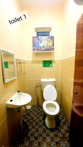 a bathroom with a toilet and a sink at CEMPAKA IRIS HOMESTAY in Kampung Bota Kiri