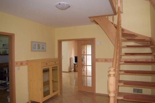 a living room with a staircase in a house at Ferienhaus Eichhörnchen am Fleesensee in Göhren-Lebbin