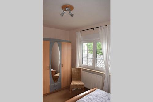a bedroom with a ceiling fan and a mirror at Ferienhaus Eichhörnchen am Fleesensee in Göhren-Lebbin