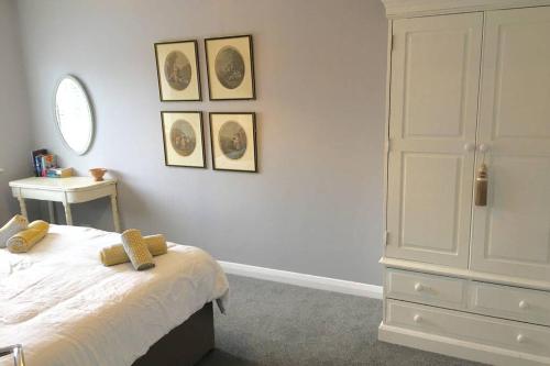 a bedroom with a bed and a dresser and a mirror at Apartment 61 in Wetherby