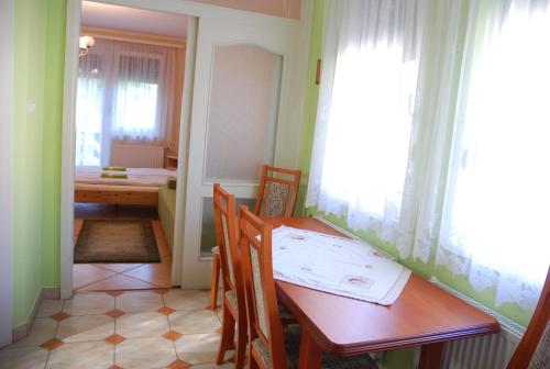 a dining room with a table and a table and chairs at Zöldike Vendégház in Kaposvár