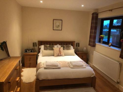 a bedroom with a bed and a window at The Oaks in Warminster