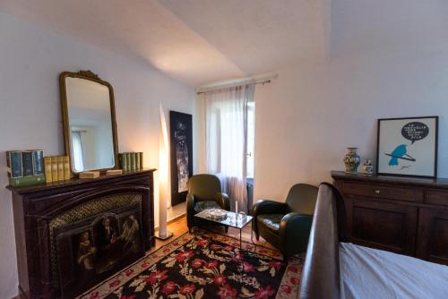 a bedroom with a fireplace and a mirror and a bed at Casa Silvana in Alba