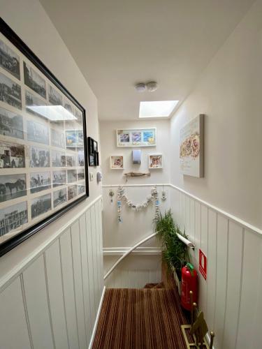 a hallway with a staircase with white walls at Mevira Appartement in Zandvoort