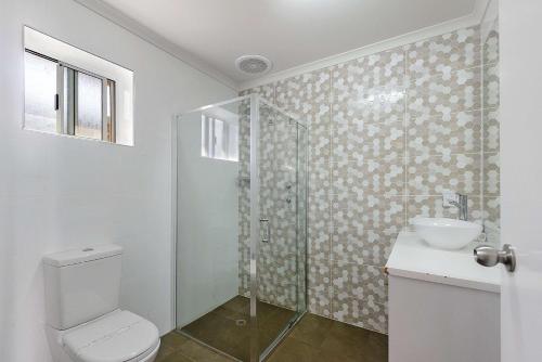 a bathroom with a shower and a toilet and a sink at Comfort Inn Flinders on Main in Port Pirie