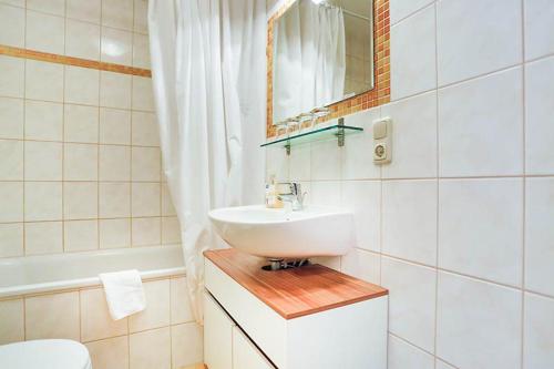 a bathroom with a sink and a mirror at H&H Apartment im Herzen der Stadt Nr 29-Henning mit Balkon in Greifswald