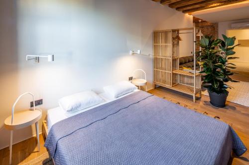 Un dormitorio con una cama azul y una planta en OnLviv Apartments Rynok Square 18 Two en Leópolis