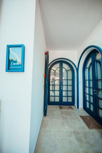 a hallway with two doors and a painting on the wall at Büyükada Loc'ada in Adalar