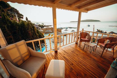 a porch with a couch and chairs on the beach at Büyükada Loc'ada in Adalar