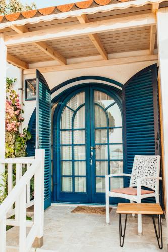 a blue door on a porch with a chair at Büyükada Loc'ada in Adalar