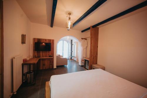 a bedroom with a bed and a television in it at Büyükada Loc'ada in Adalar
