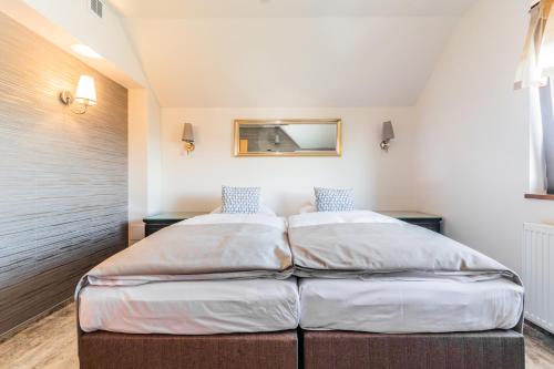 a bedroom with two beds in a room at Hotel Kahlberg in Krynica Morska