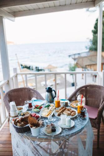 a table with food and drinks on a balcony at Büyükada Loc'ada in Adalar