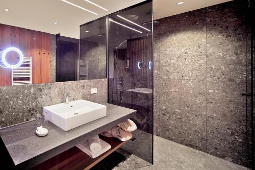 a bathroom with a sink and a shower at Gut Sonnberghof in Mittersill