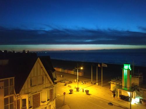 a city street at night with a green light at Sea view & Beach Studio Apartment - Blue Horizon in Dunkerque