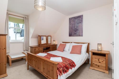 a bedroom with a large bed and a window at Historic Village, Rare Find, Amazing Views in Ballater