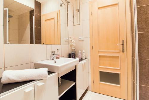 a white bathroom with a sink and a shower at In the Hearth of the City Centre, Old Town Square - 3min in Prague
