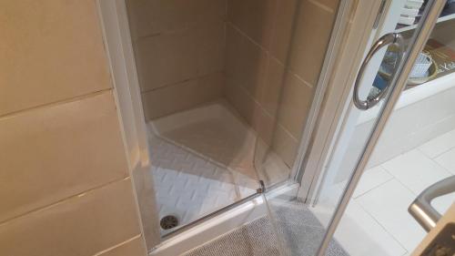 a shower with a glass door in a bathroom at Awesomehouse centre Bari in Bari