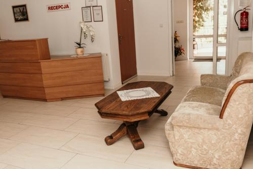 a living room with a couch and a coffee table at Motel Łasuch in Osjaków