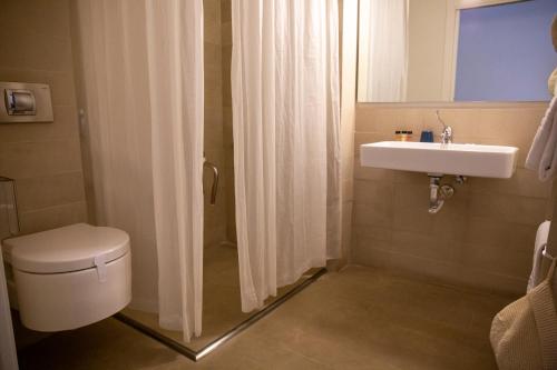 a bathroom with a toilet and a sink and a shower at Shalai - Exclusive SPA and small gourmet hotel in Linguaglossa