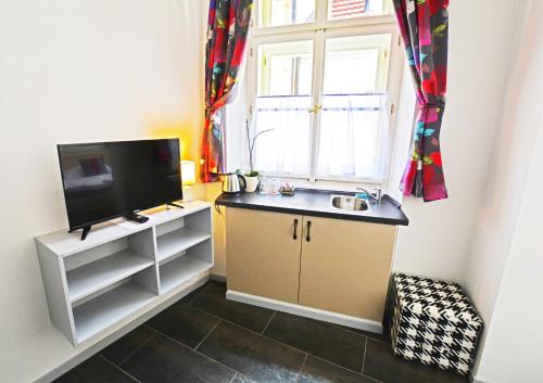 a small kitchen with a sink and a window at Historic Centre Residence in Prague