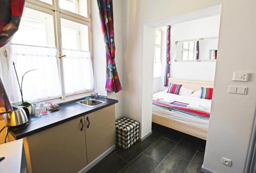 a bathroom with a sink and a bed in a room at Historic Centre Residence in Prague