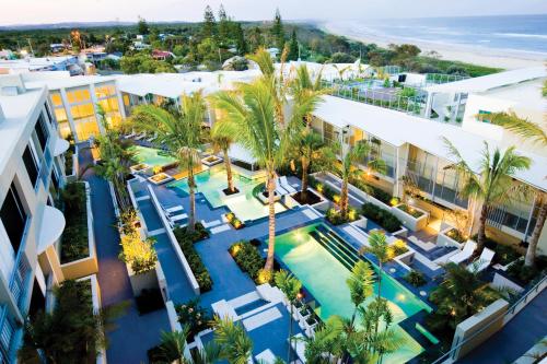 an aerial view of a resort with a pool and palm trees at The Beach Cabarita in Cabarita Beach