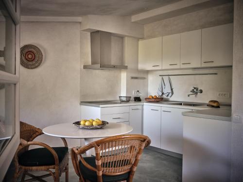 a kitchen with a table with a bowl of fruit on it at Lithalona Villas & Houses in Marathias