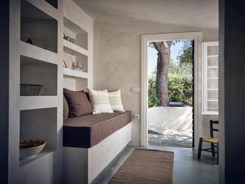 a room with a bed and a door leading to a patio at Lithalona Villas & Houses in Marathias