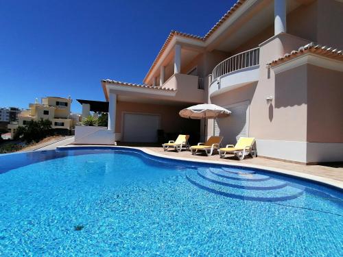 a swimming pool in front of a villa at Casa Rosa in Lagos