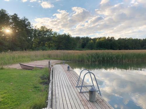 a wooden dock with a boat on the water at Hotel Stallbacken Nagu in Nauvo