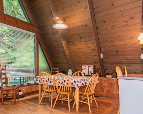 a dining room with a table and chairs at Smoky Bear Hideaway in Gatlinburg