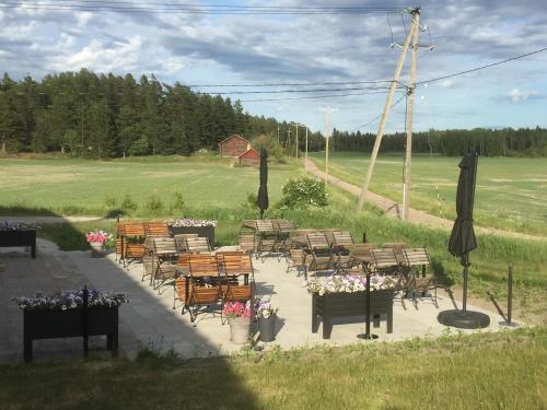 a group of chairs and tables with flowers on a patio at Hotel Stallbacken Nagu in Nauvo