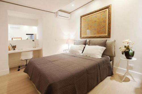 a bedroom with a bed and a painting on the wall at CARTARI9 home in Rome