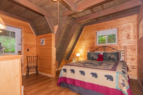 a bedroom with a bed in a log cabin at Smoky Bear Hideaway in Gatlinburg