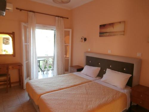 1 dormitorio con cama y ventana grande en River Studios & Apartments, en Mesongi