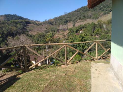 a wooden bridge on the side of a hill at Lumiar Chalé Jardim do Sossego in Lumiar