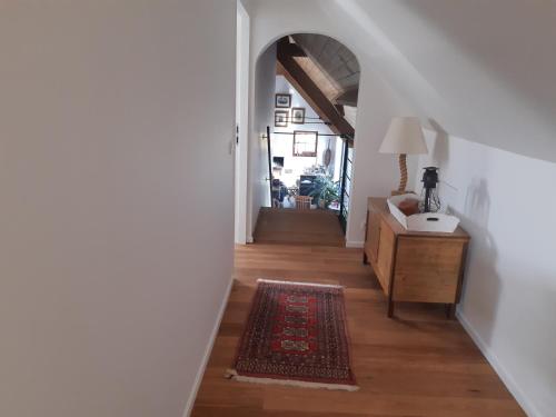 a hallway with a stairway leading to a living room at Het Meikenshof in Dentergem