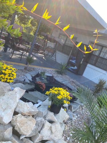 a garden with rocks and flowers in a yard at Madill Inn in Madill
