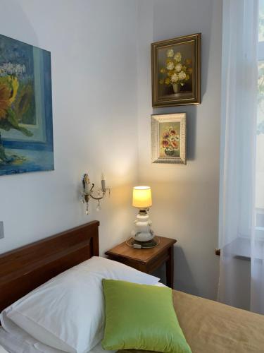 a bedroom with a bed and a lamp on a table at NB Apartments Riga Old Town in Rīga
