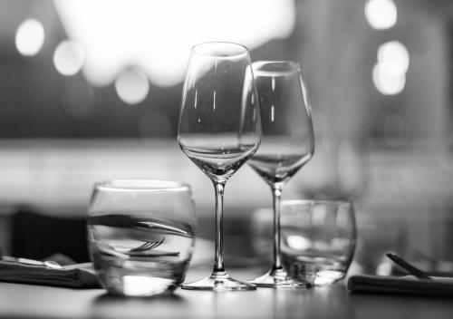 three wine glasses sitting on top of a table at Hotel le Sacca, nouvelle équipe in Cauterets