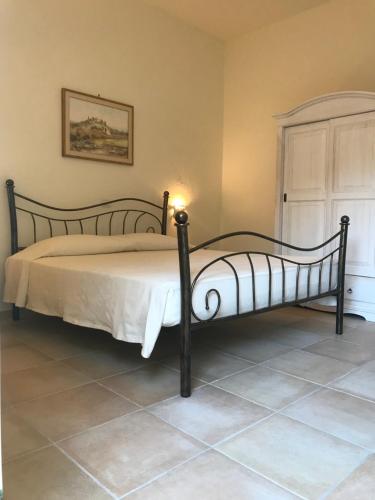a bedroom with a large bed with a candle on it at Domo Antiga Guest Rooms in Sorso