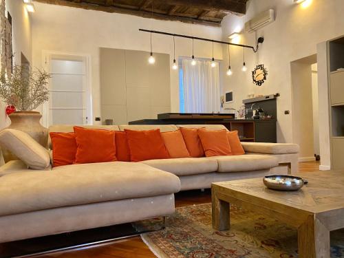 a living room with a couch and a table at Kindness art apartment in historic center in Arona