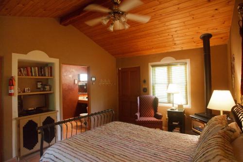 a bedroom with a bed and a wooden ceiling at Dreamcatcher B&B in Taos