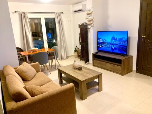 
A television and/or entertainment center at Helios Apartments - Beach of Lachania Rhodes
